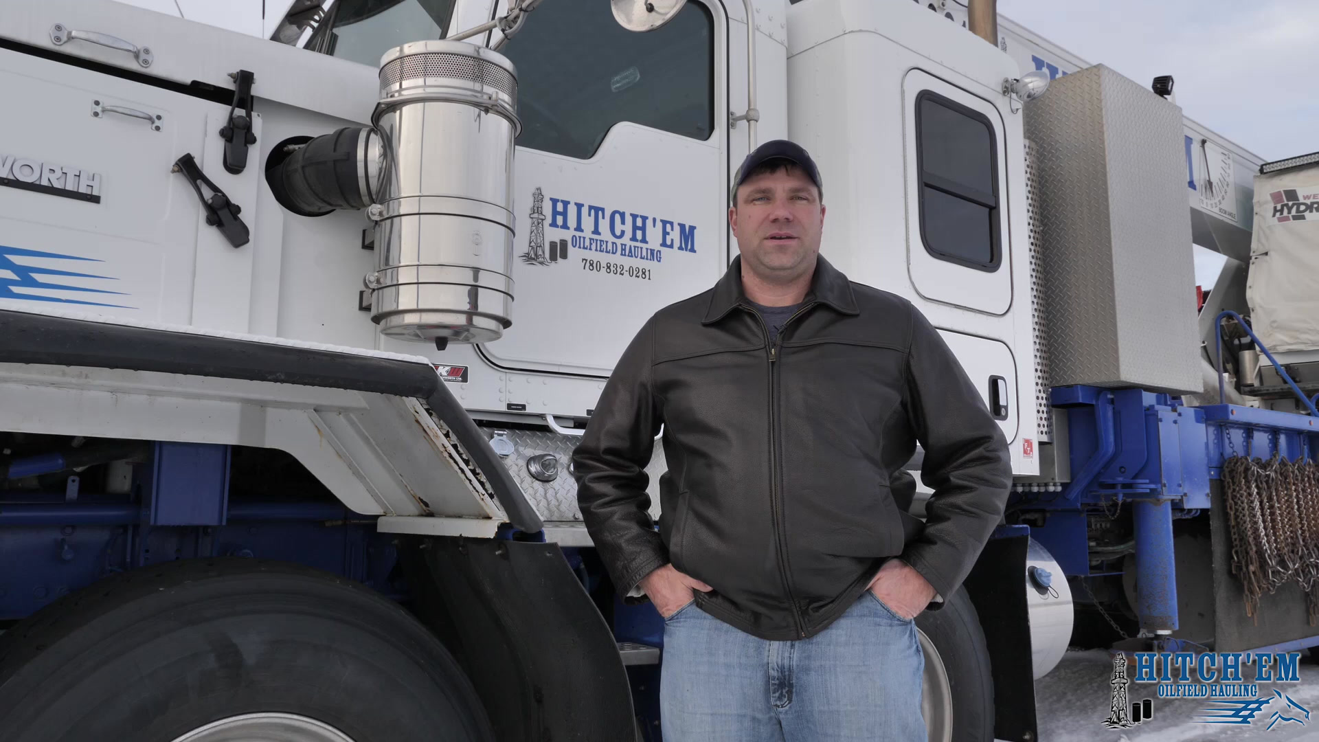 Mitch Sutherland, owner of Hitch'em Oilfield Hauling, in front of a branded Kenworth winch tractor